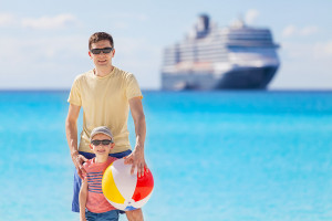 young father and his little son enjoying beach vacation and playing with beach ball, cruise and beach vacation concept
