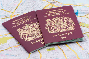 London, UK - December 11, 2013; Two United Kingdom biometric passports on a European Road Map taken in a studio.
