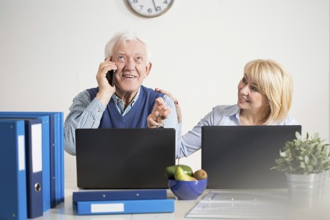 Elderly businessman talking on the phone with client