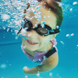 Little girl practicing her swimming