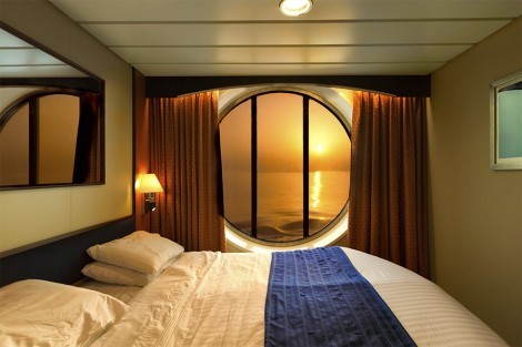 Sunset at a cruise ship cabin with queen size bed
