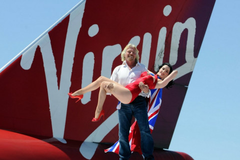 Founder and President of Virgin Group Sir Richard Branson (L) and burlesque artist Dita Von Teese appear with a Virgin Atlantic Airways 747-400 aircraft at McCarran International Airport June 15, 2010 in Las Vegas, Nevada. Branson is celebrating his British airline's 10th anniversary of flying between London and Las Vegas.